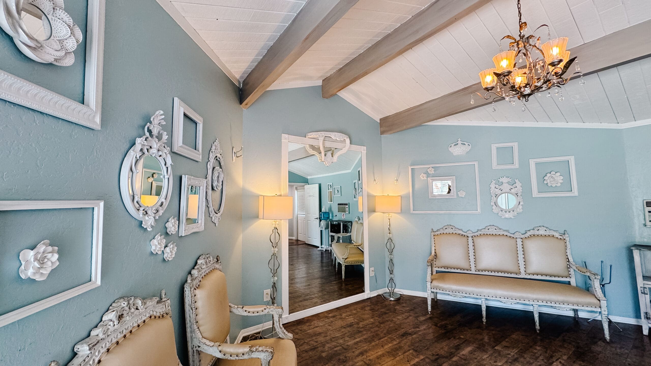 Bright and airy bridal suite at Los Willows wedding venue in Fallbrook, CA, styled with vintage-inspired furniture, soft neutral decor, and large windows that fill the room with natural light.