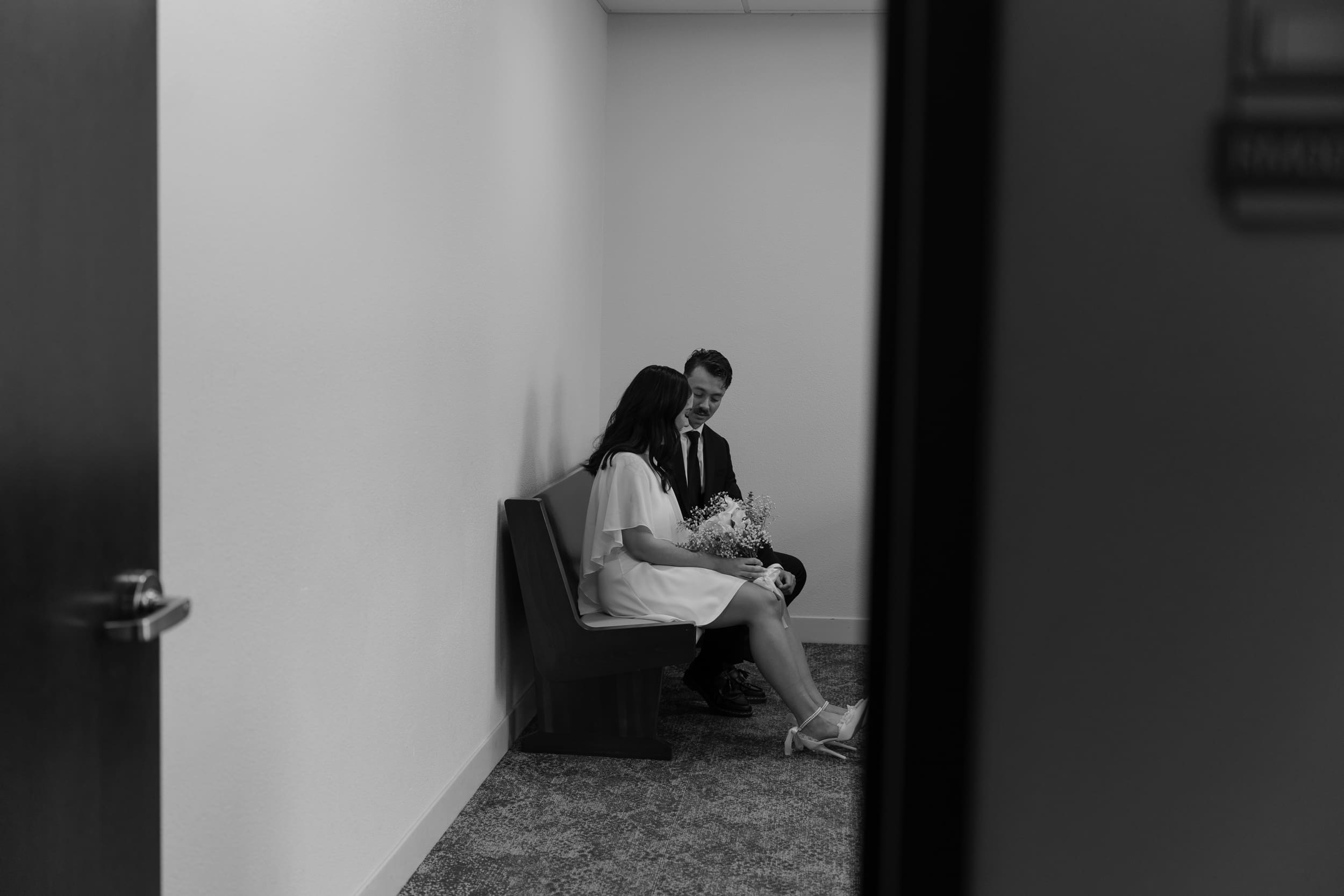 Photographer documenting a quiet courthouse wedding ceremony