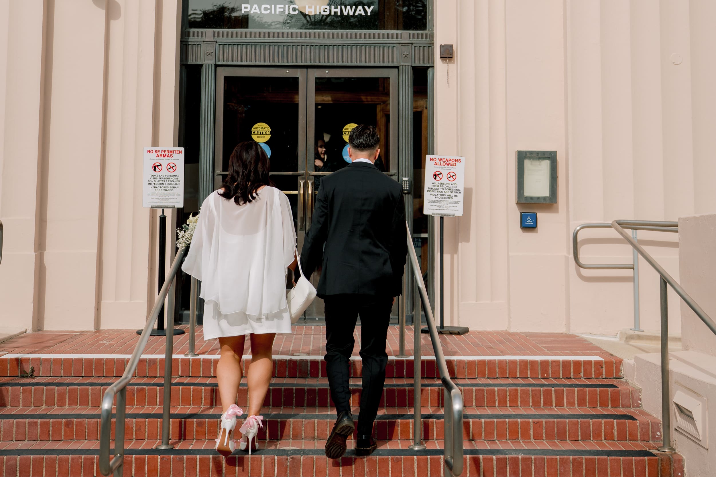 San Diego courthouse wedding photography capturing bride and groom entering the courthouse building